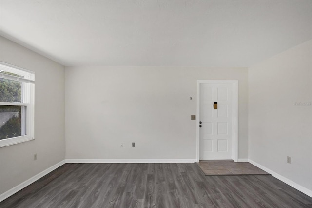 5800 Hollywood Blvd Unit 312, Sarasota, FL 34231 - spare room featuring baseboards and dark wood-style floors