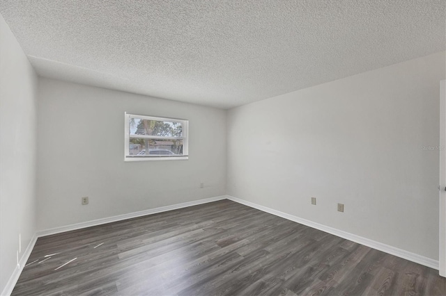 5800 Hollywood Blvd Unit 312, Sarasota, FL 34231 - spare room featuring a textured ceiling, baseboards, and dark wood-type flooring
