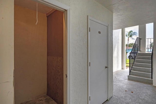 5800 Hollywood Blvd Unit 312, Sarasota, FL 34231 - corridor with attic access and a textured wall