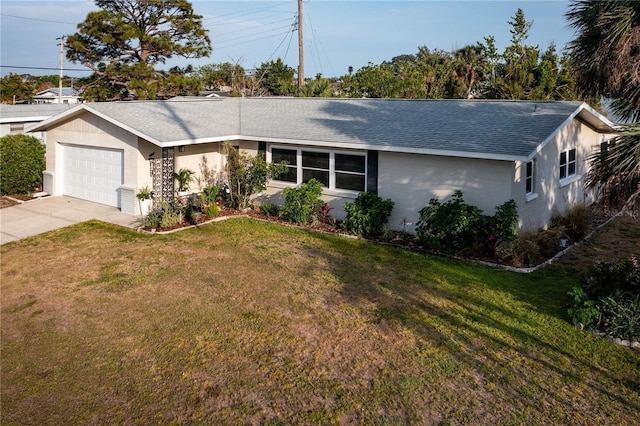 single story home with roof with shingles, concrete driveway, a front yard, and an attached garage