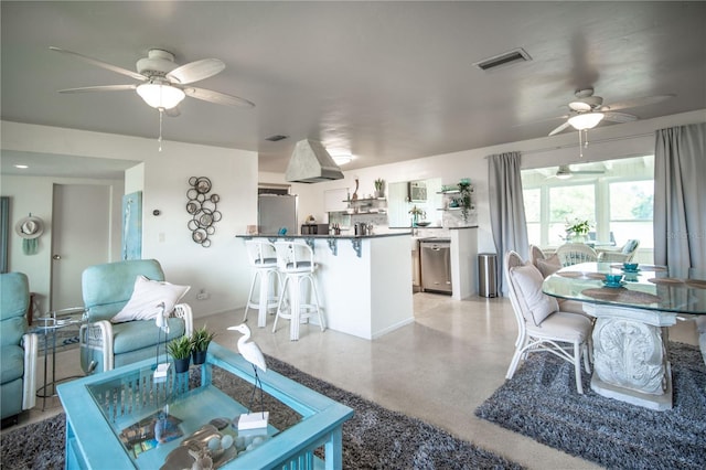 living area with a ceiling fan, visible vents, and baseboards