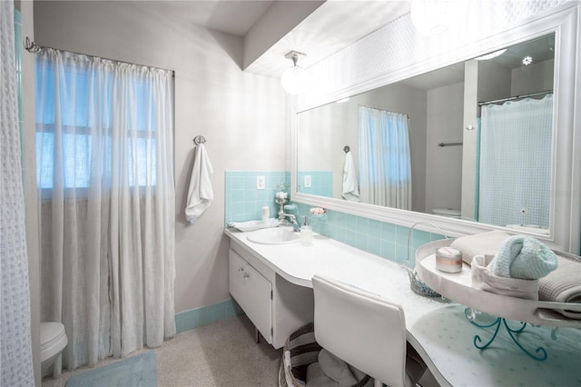 full bathroom with toilet, vanity, and tasteful backsplash