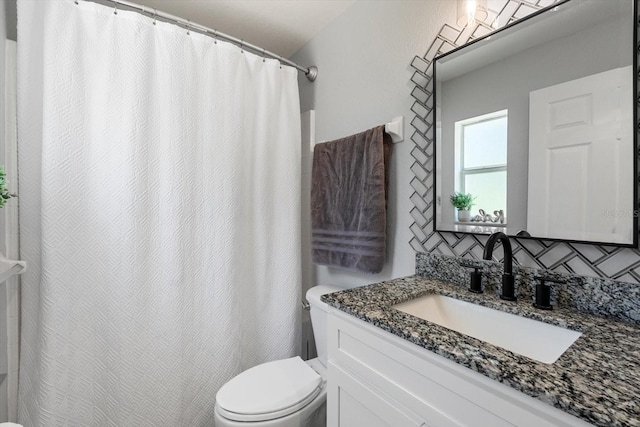 bathroom featuring toilet and vanity