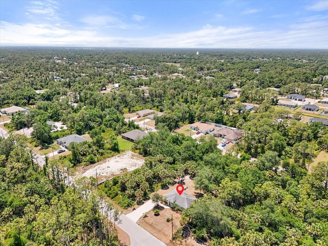 drone / aerial view with a wooded view