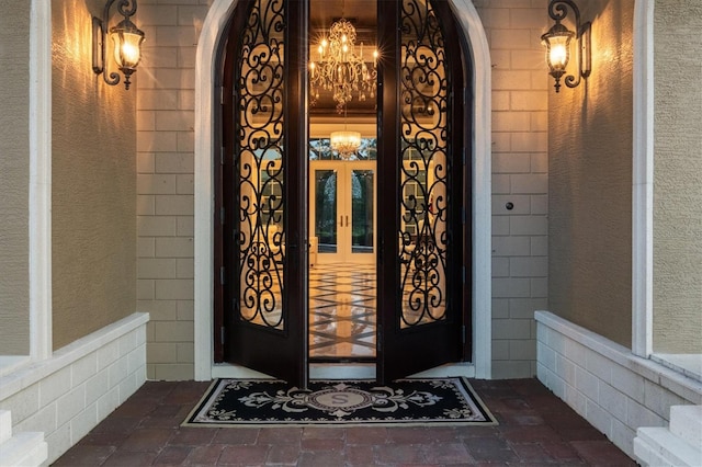entrance to property with a porch and french doors