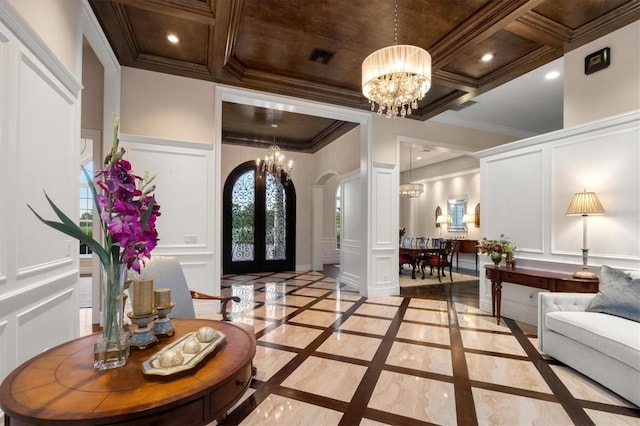 entrance foyer with arched walkways, a notable chandelier, ornamental molding, and a decorative wall