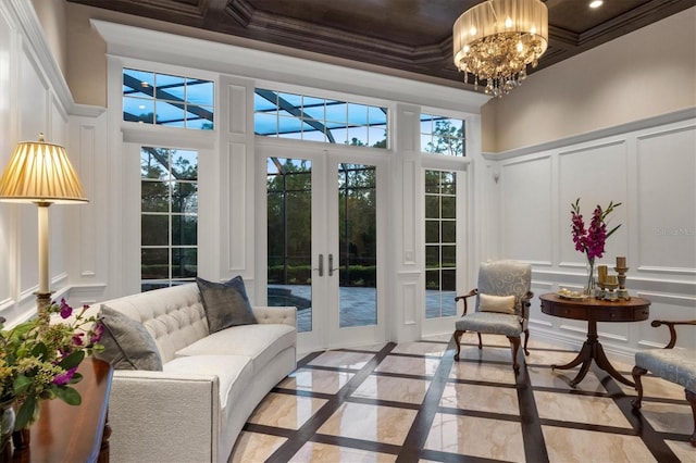 sunroom / solarium featuring an inviting chandelier and french doors