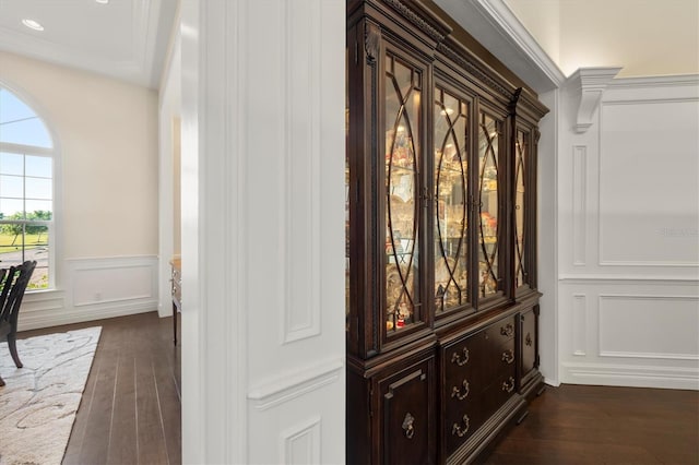 room details with a wainscoted wall, wood finished floors, and a decorative wall