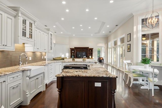 kitchen featuring decorative backsplash, a peninsula, glass insert cabinets, dark wood-style floors, and recessed lighting