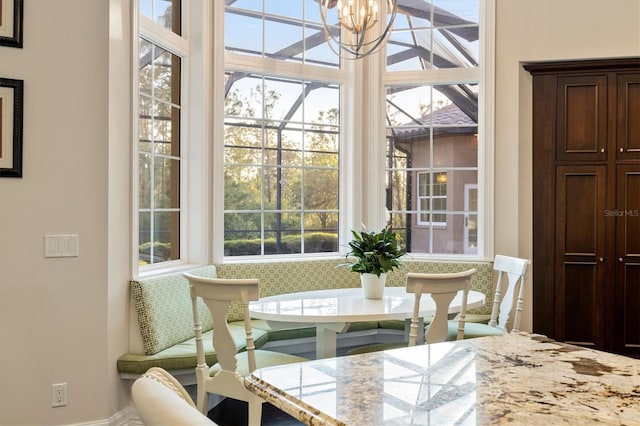 dining room with an inviting chandelier and baseboards