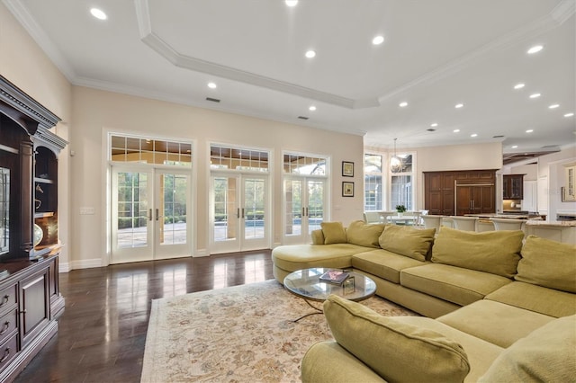 living area featuring crown molding, french doors, recessed lighting, a tray ceiling, and dark wood-style floors