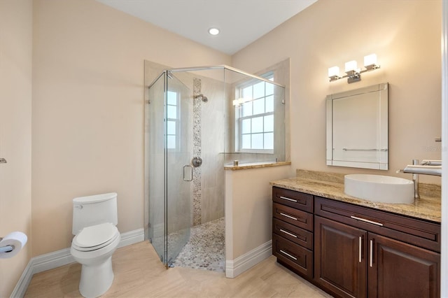 full bathroom with vanity, toilet, baseboards, and a stall shower