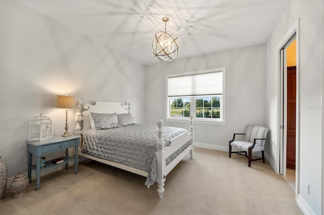 carpeted bedroom featuring baseboards and a chandelier