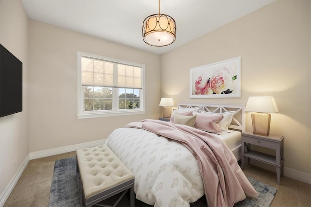 bedroom featuring baseboards and light carpet