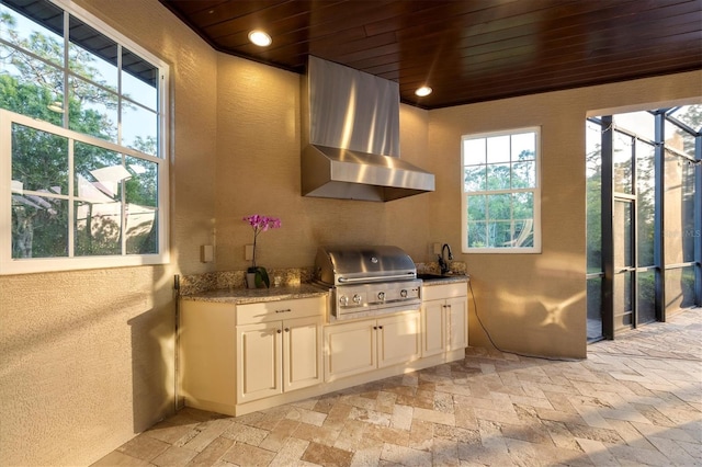 kitchen featuring extractor fan, wooden ceiling, and a wealth of natural light