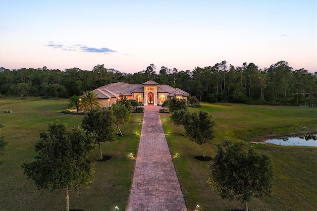exterior space featuring a water view and a yard