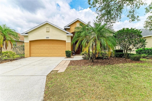 6546 Blue Grosbeak Cir, Lakewood Ranch, FL 34202 - view of front of property with stucco siding, an attached garage, concrete driveway, and a front yard