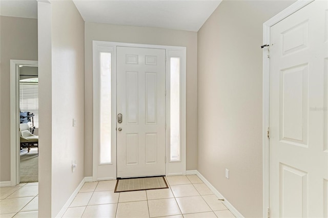 6546 Blue Grosbeak Cir, Lakewood Ranch, FL 34202 - foyer entrance with light tile patterned floors and baseboards