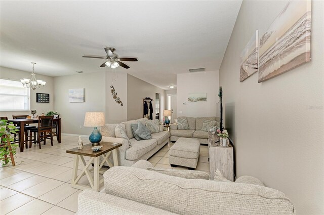 6546 Blue Grosbeak Cir, Lakewood Ranch, FL 34202 - living area with light tile patterned floors, a chandelier, and a ceiling fan