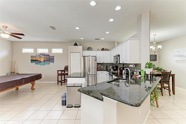 6546 Blue Grosbeak Cir, Lakewood Ranch, FL 34202 - kitchen with stainless steel appliances, a sink, tasteful backsplash, a peninsula, and light tile patterned floors