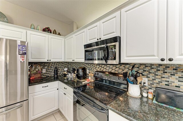 6546 Blue Grosbeak Cir, Lakewood Ranch, FL 34202 - kitchen with stainless steel appliances, light tile patterned floors, and white cabinetry