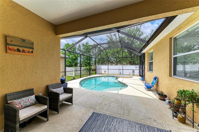6546 Blue Grosbeak Cir, Lakewood Ranch, FL 34202 - view of pool with a patio, a fenced backyard, glass enclosure, and a pool with connected hot tub