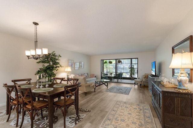 536 Lakeside Dr Unit 0, Bradenton, FL 34210 - dining space with light wood-style flooring and a chandelier