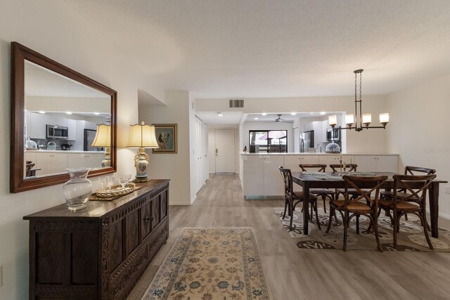 536 Lakeside Dr Unit 0, Bradenton, FL 34210 - dining area with light wood finished floors and baseboards