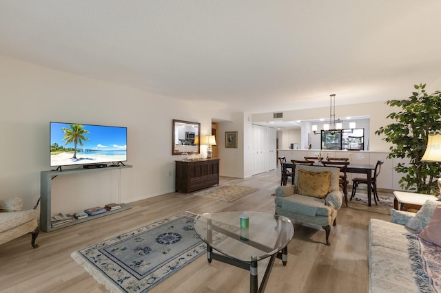 536 Lakeside Dr Unit 0, Bradenton, FL 34210 - living area featuring light wood-type flooring and a chandelier