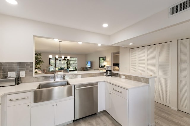 536 Lakeside Dr Unit 0, Bradenton, FL 34210 - kitchen featuring stainless steel dishwasher, a sink, light countertops, light wood finished floors, and recessed lighting