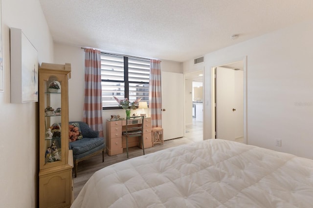 536 Lakeside Dr Unit 0, Bradenton, FL 34210 - bedroom featuring a textured ceiling and light wood-style floors