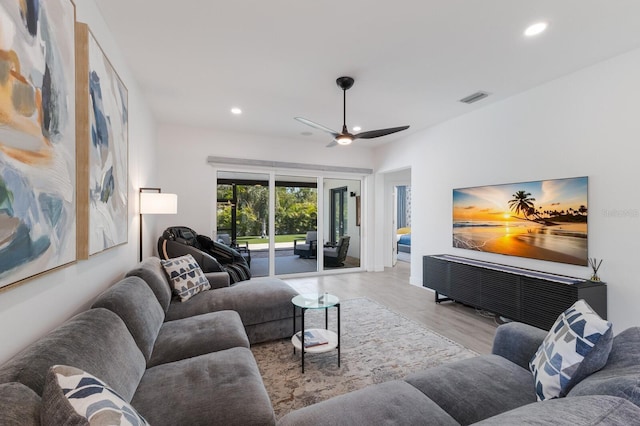 living area with visible vents, wood finished floors, a ceiling fan, and recessed lighting