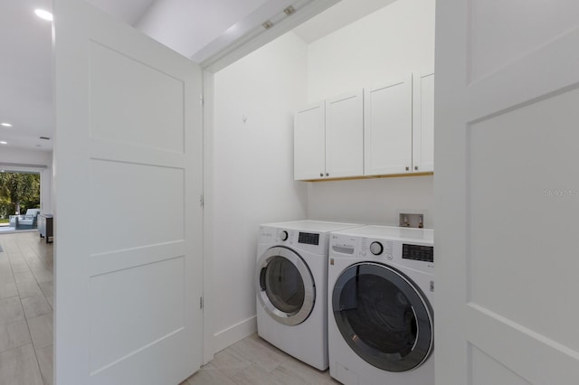 laundry area with washing machine and dryer, recessed lighting, cabinet space, and baseboards