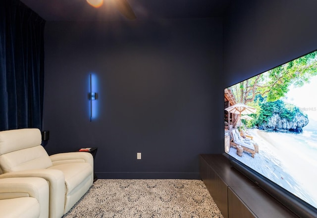living area with a ceiling fan and baseboards