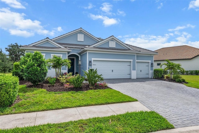 13319 Deep Blue Pl, Bradenton, FL 34211 - ranch-style house with decorative driveway, an attached garage, and a front lawn
