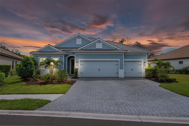 13319 Deep Blue Pl, Bradenton, FL 34211 - view of front of home with decorative driveway, an attached garage, and a lawn
