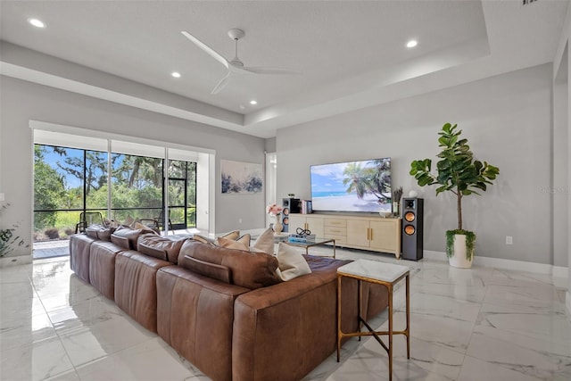 13319 Deep Blue Pl, Bradenton, FL 34211 - living area with light marble finish flooring, ceiling fan, recessed lighting, baseboards, and a tray ceiling