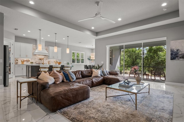 13319 Deep Blue Pl, Bradenton, FL 34211 - living room featuring light marble finish flooring, recessed lighting, a ceiling fan, a textured ceiling, and baseboards