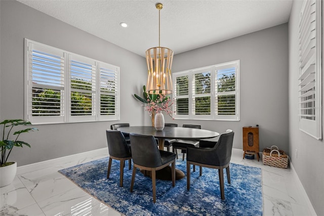 13319 Deep Blue Pl, Bradenton, FL 34211 - dining area with marble look tile flooring, baseboards, plenty of natural light, a textured ceiling, and recessed lighting