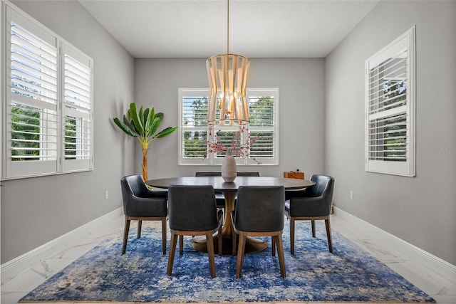 13319 Deep Blue Pl, Bradenton, FL 34211 - dining space with marble look tiles, a chandelier, and baseboards