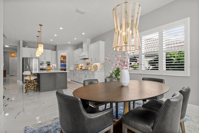 13319 Deep Blue Pl, Bradenton, FL 34211 - dining area featuring light marble finish floors, a chandelier, recessed lighting, and baseboards