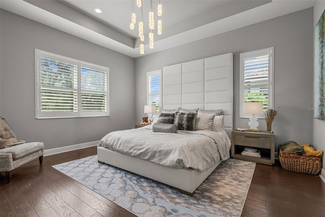 13319 Deep Blue Pl, Bradenton, FL 34211 - bedroom with baseboards, dark wood-style floors, a raised ceiling, and recessed lighting
