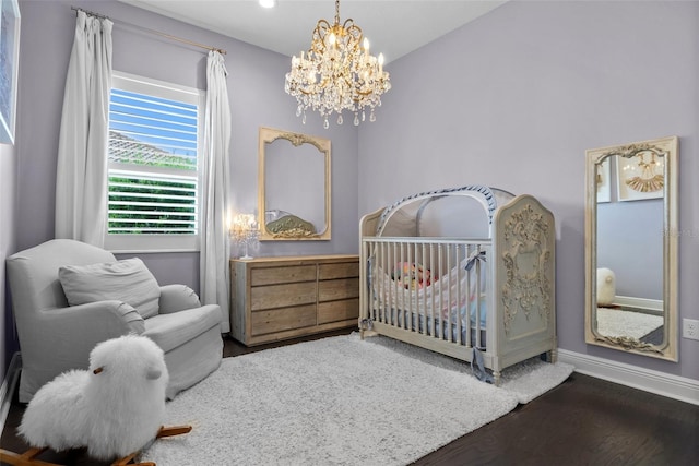 13319 Deep Blue Pl, Bradenton, FL 34211 - bedroom featuring a crib, a chandelier, wood finished floors, and baseboards