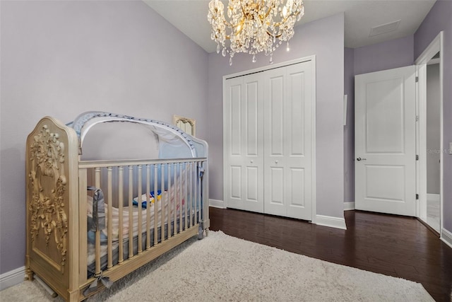 13319 Deep Blue Pl, Bradenton, FL 34211 - bedroom with a closet, baseboards, wood finished floors, and a chandelier