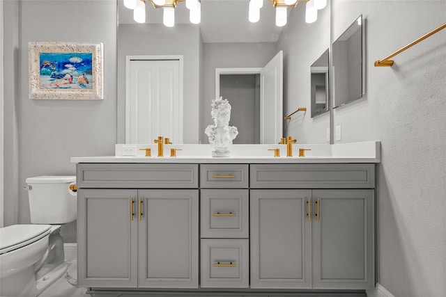 13319 Deep Blue Pl, Bradenton, FL 34211 - bathroom featuring double vanity, toilet, and baseboards