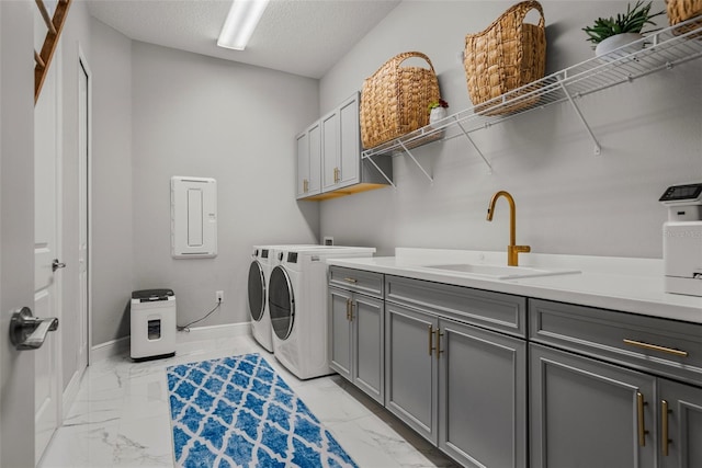 13319 Deep Blue Pl, Bradenton, FL 34211 - laundry room featuring light marble finish floors, washing machine and clothes dryer, cabinet space, baseboards, and a textured ceiling