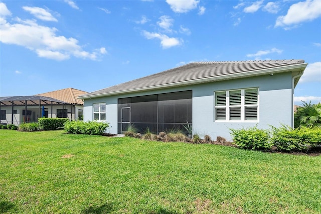 13319 Deep Blue Pl, Bradenton, FL 34211 - back of property with stucco siding, a lawn, and a tiled roof