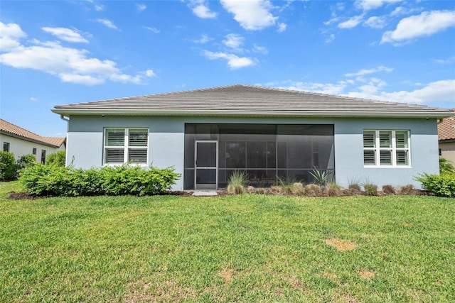 13319 Deep Blue Pl, Bradenton, FL 34211 - rear view of property featuring stucco siding, a lawn, a tiled roof, and a sunroom