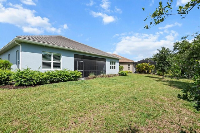 13319 Deep Blue Pl, Bradenton, FL 34211 - back of house with a yard, stucco siding, and a tile roof