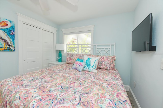 205 Elm Ave, Anna Maria, FL 34216 - bedroom with baseboards, wood finished floors, a ceiling fan, and a closet